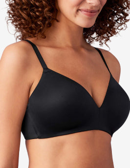 Woman wearing a black bra against a neutral background