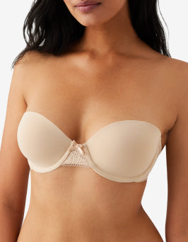 Strapless bra worn by a model on a plain background