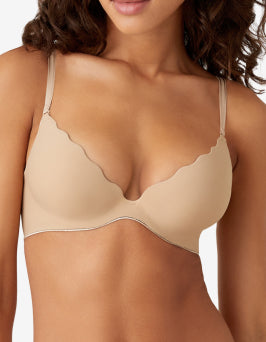 Push up bra worn by a model on a plain background